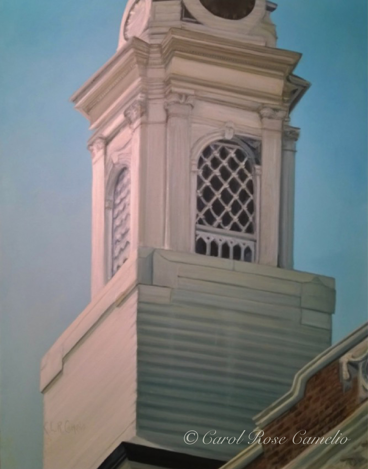 Church Tower: A white-washed wooden church tower, with a window and clock, on a sunny day.