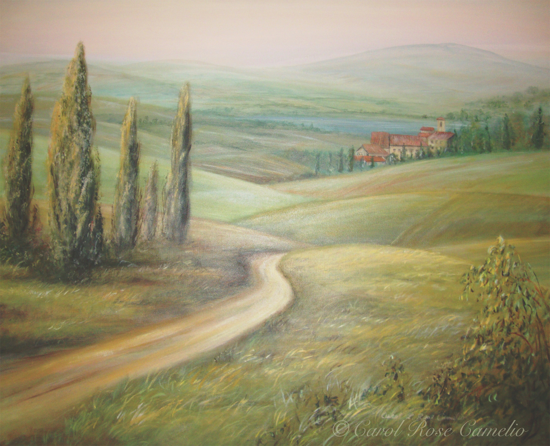 Tuscany: A countryside scene of a path leading across rolling hills.